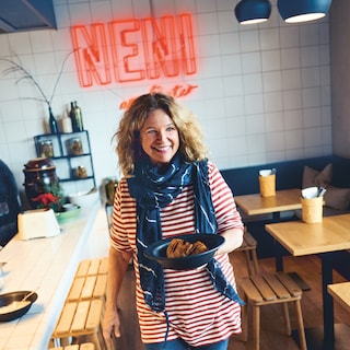 Haya Molcho carries a plate with her signature dish