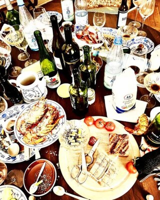 Messy dinner table with bottles and plates