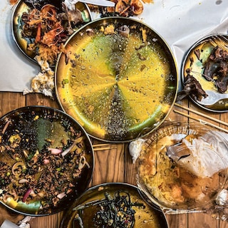 A table full of messy plates eaten empty