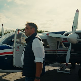 Thomas Bonk standing beside a plane