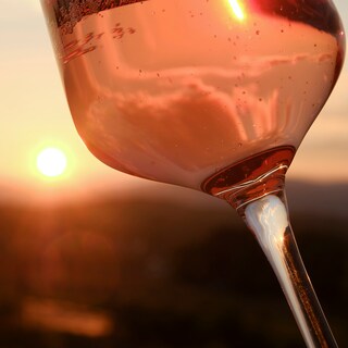 Wine glass in front of the sunset